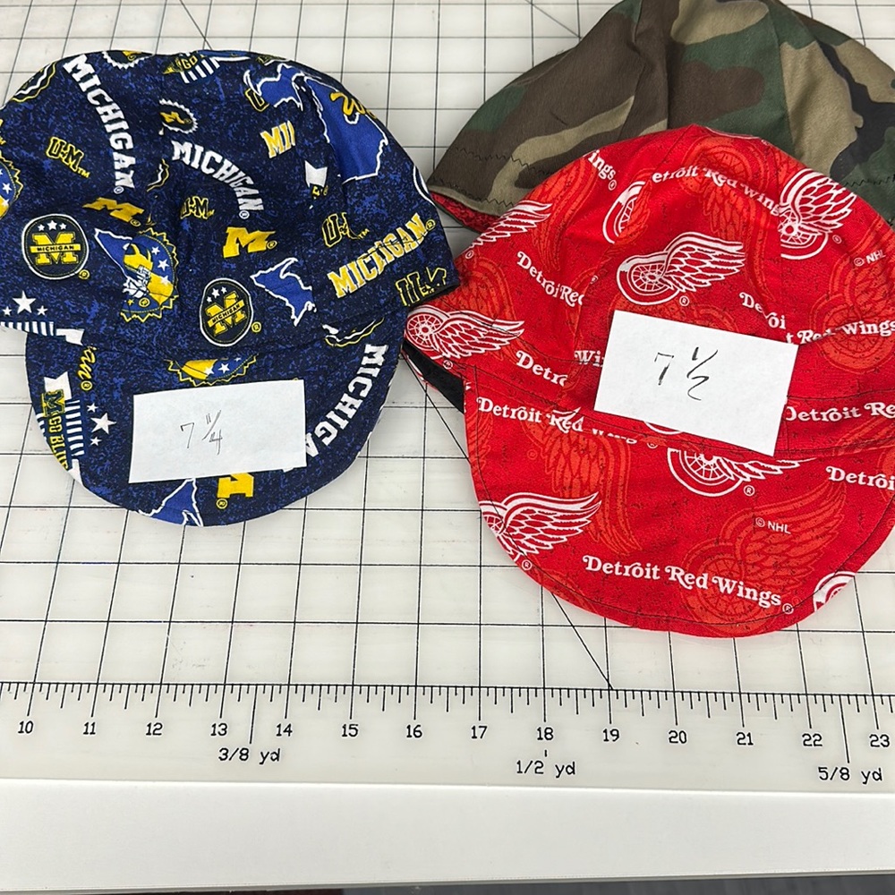One Bundle -1 Red Wings 7.5 / 1 Camo  7.5 and  1 UofM size 7.25 welding caps